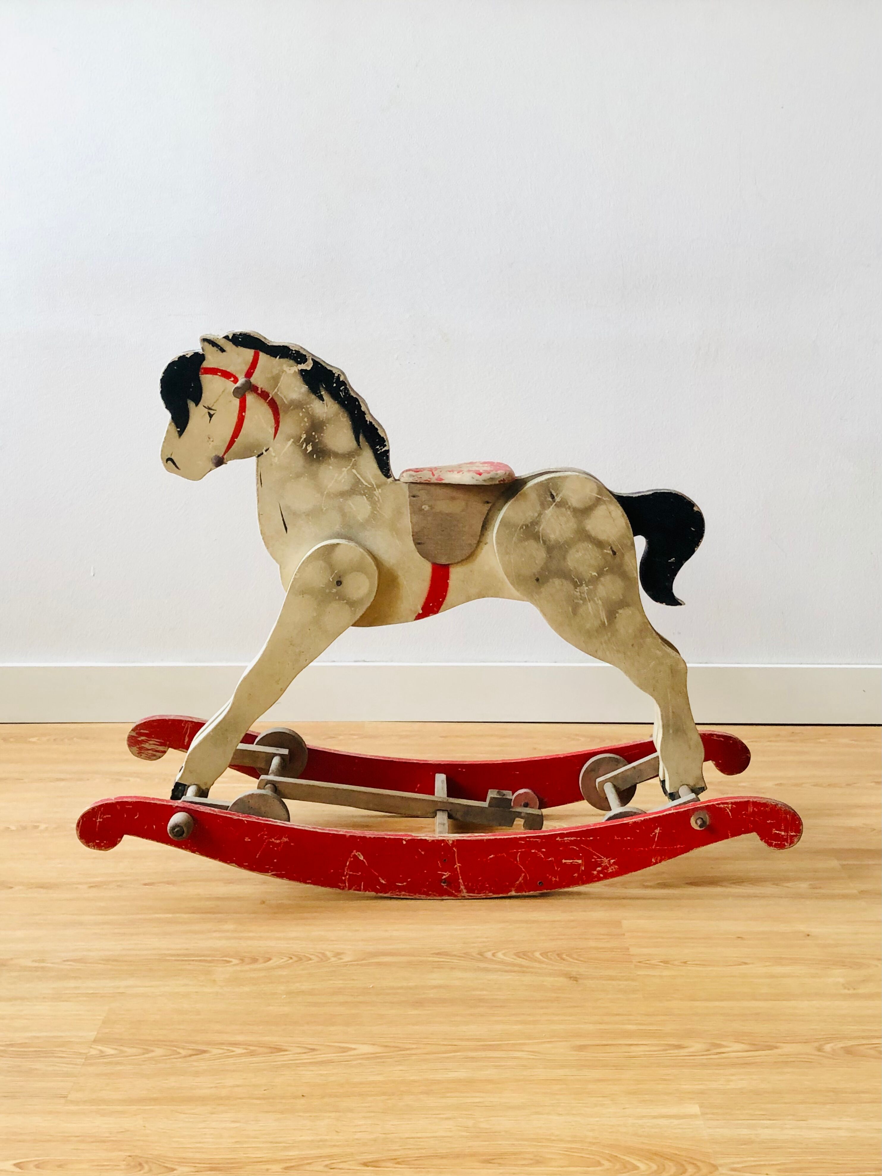 Cheval en bois ancien à bascule et à roulettes