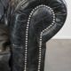 Spacious black cow leather chesterfield armchair with distinctive character