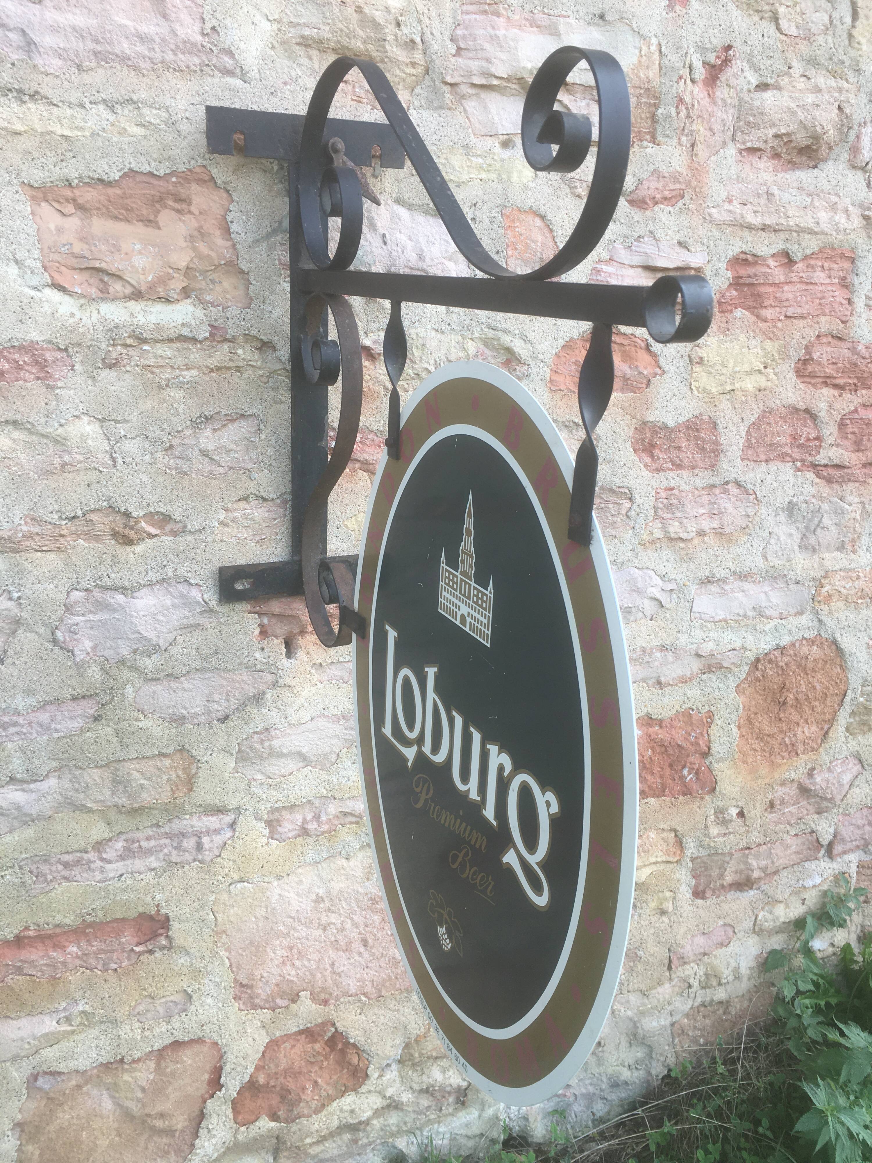 Double-sided "Loburg Beer" metal sign on wrought iron bracket