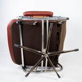 Armchair upholstered with red leather and frame of metal, of danish design from the 1960s