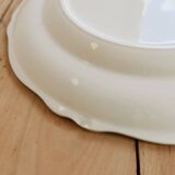 Round vintage ivory earthenware serving dish with scalloped rim.
