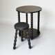 Set of side table and 2 stools, stained black wood, Circa 1950.