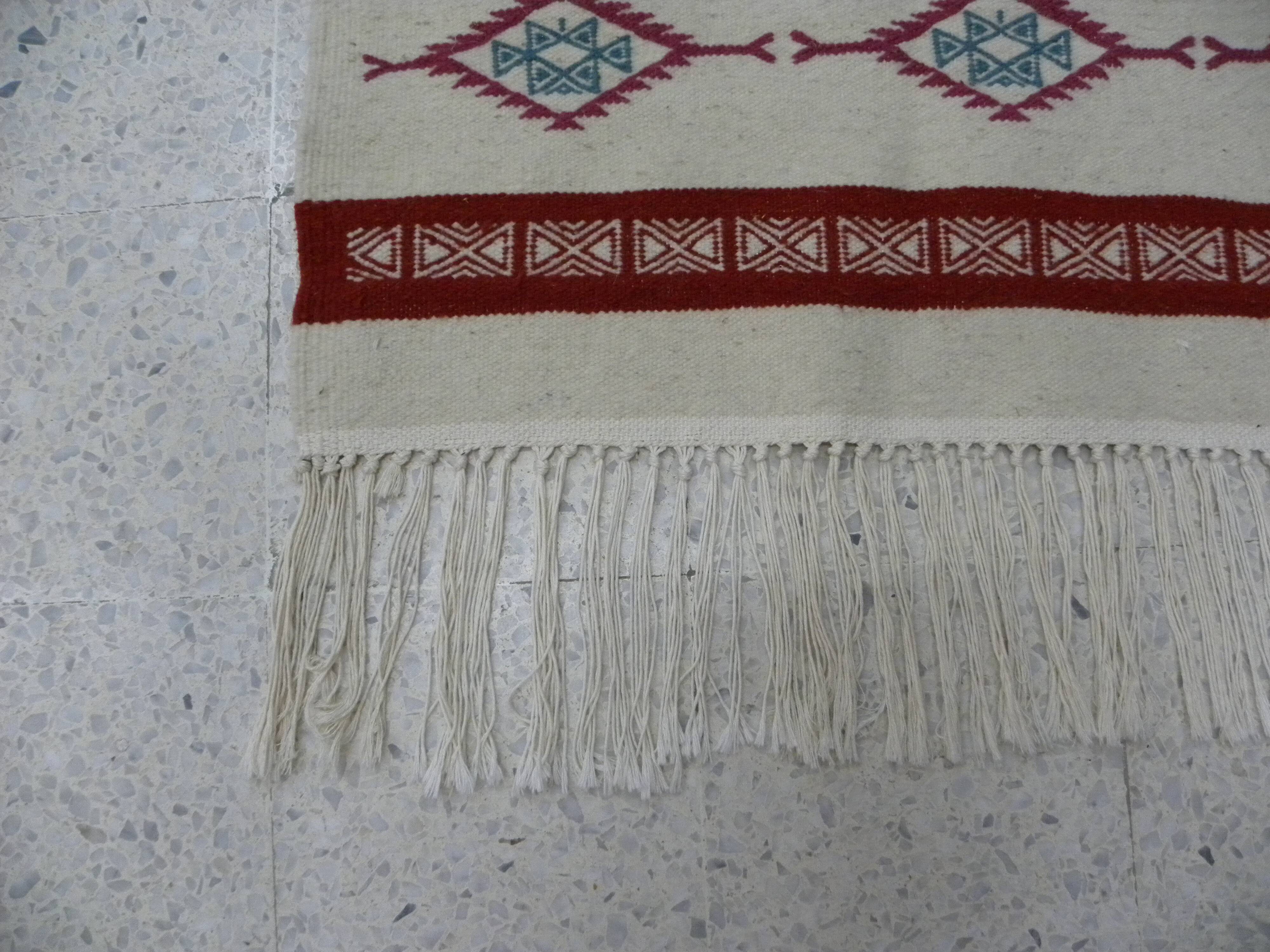 Tribal bohemian kilim rug with geometric pattern in wool.