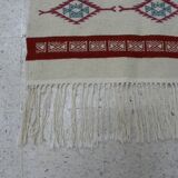 Tribal bohemian kilim rug with geometric pattern in wool.