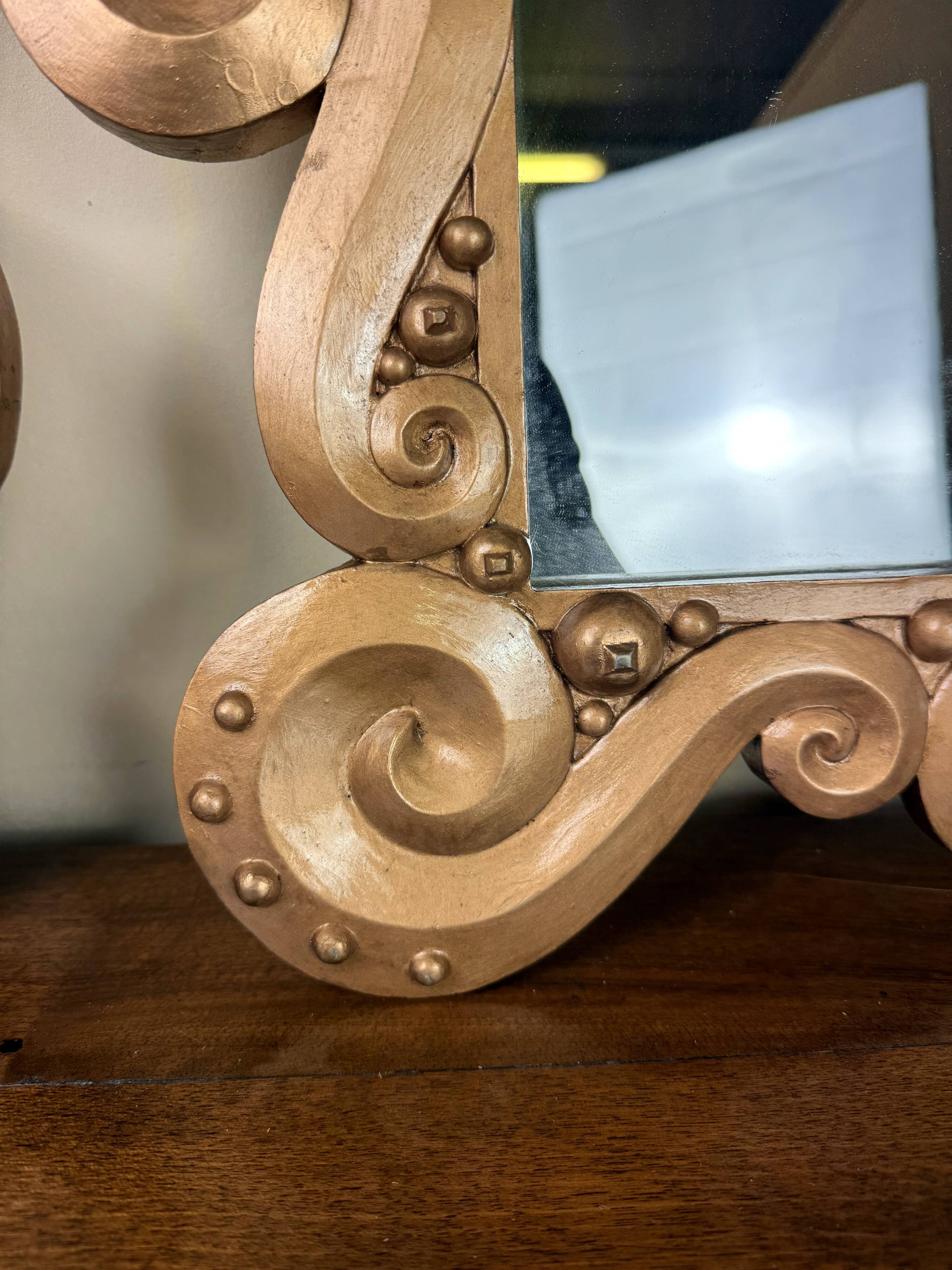 According to the model “the waves” by Jean Boggio: pair of designer gold mirrors circa 1980