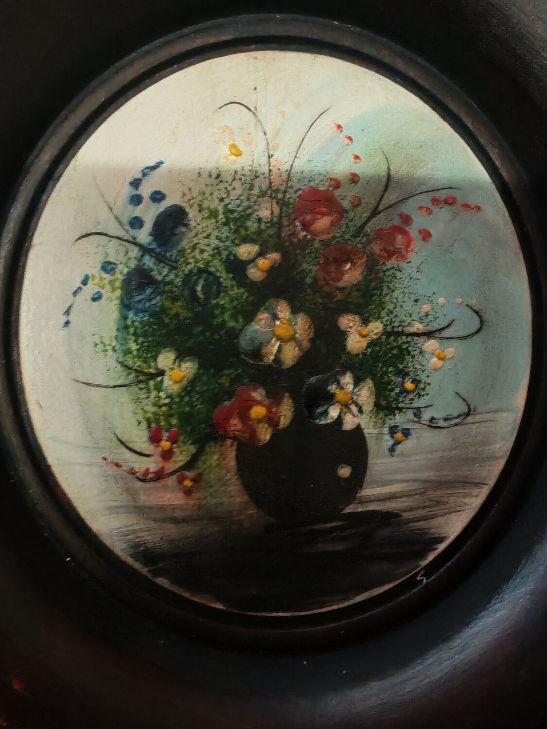 Set of three miniature flowers in a vase.