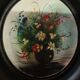 Set of three miniature flowers in a vase.