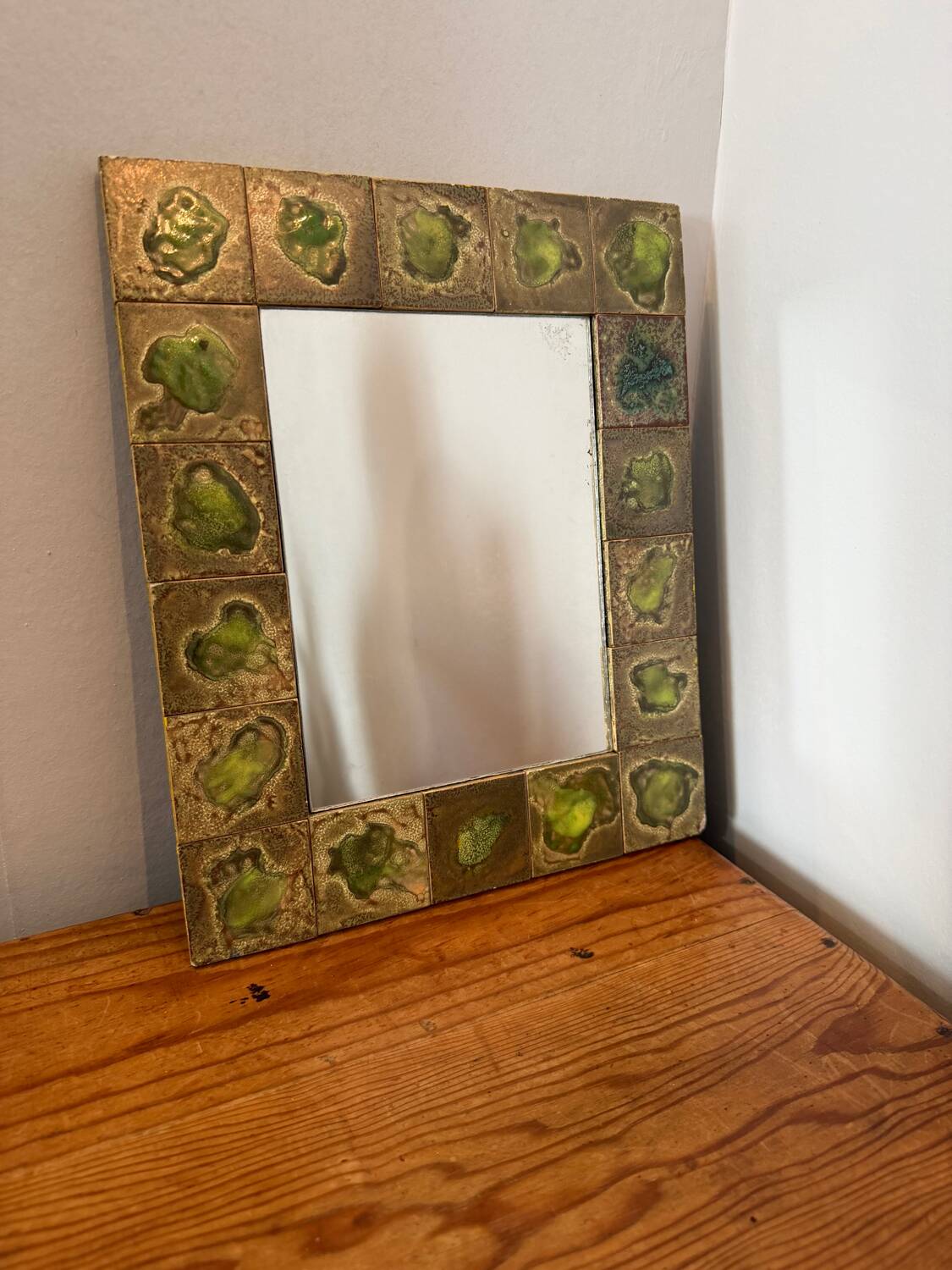 Vintage 1960s green and brown glazed ceramic mirror.