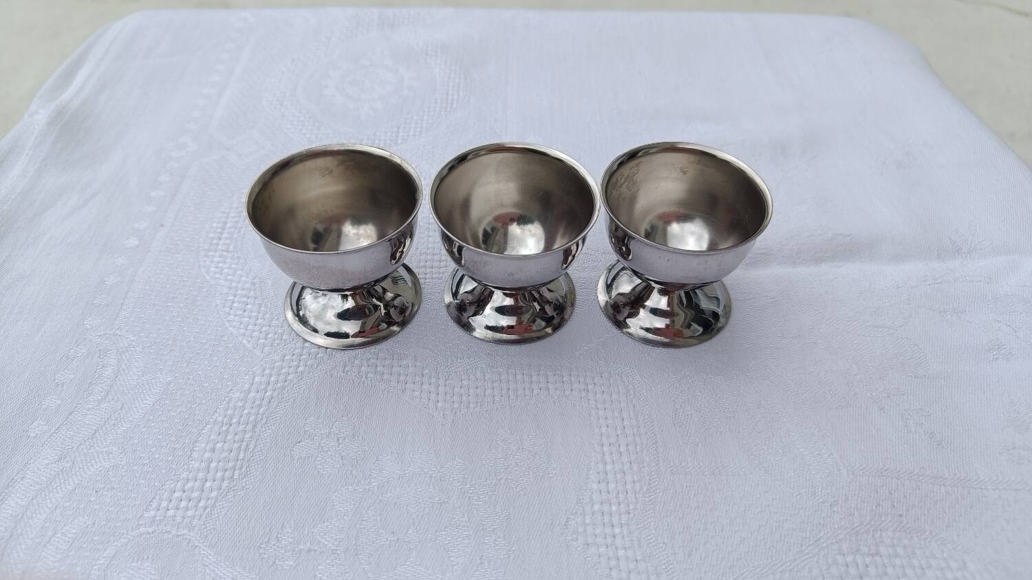 A set of 3 egg cups by Guy Degrenne.