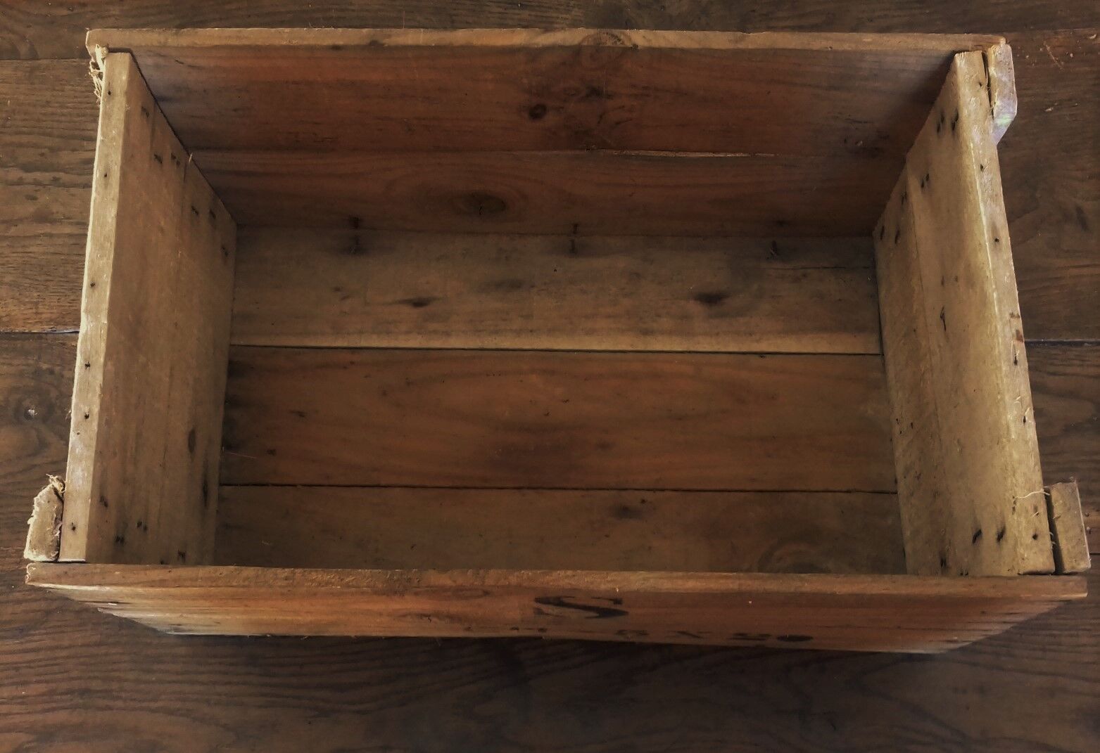 Wooden case with letters in black inck