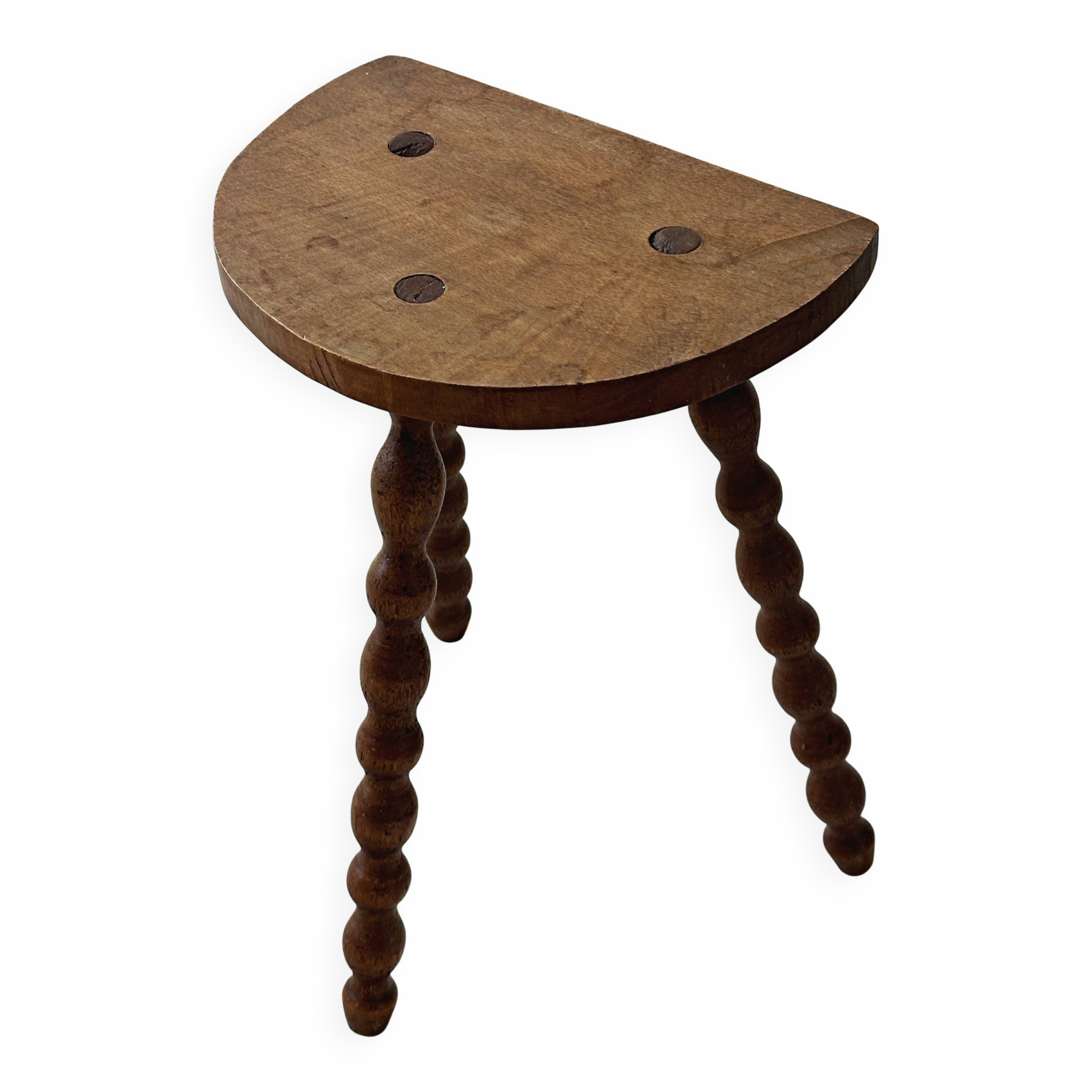 Antique solid wood stool with turned legs.