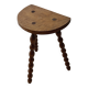 Antique solid wood stool with turned legs.