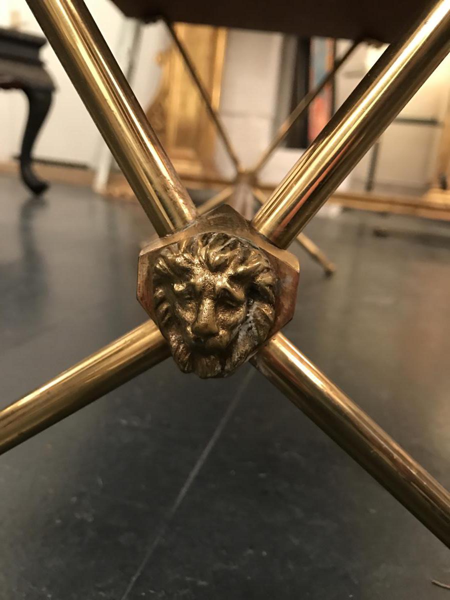 Golden brass table and lion heads circa 1950
