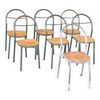 Set of 7 metal chairs by René Herbst with wooden seats.