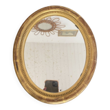 Oval mirror in gilded wood.