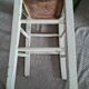 Vintage wooden stool with white peeling paint