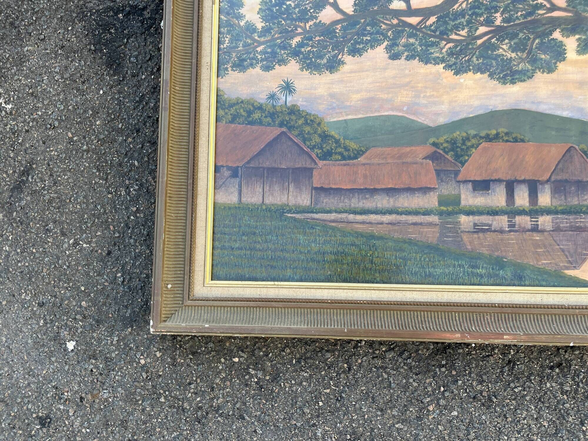 Large naive oil painting signed Medrano: rice field and buffalo, village with roofs of