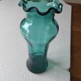 Blown glass vase with a flared neck and wavy rim.