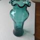 Blown glass vase with a flared neck and wavy rim.