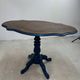 Wooden gueridon with a violin-shaped top in Rio rosewood, central base resting on four legs, reinterpreted in Baltic blue.