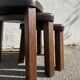 Nested tripod tables made of solid wood, in a modernist brutalist style.