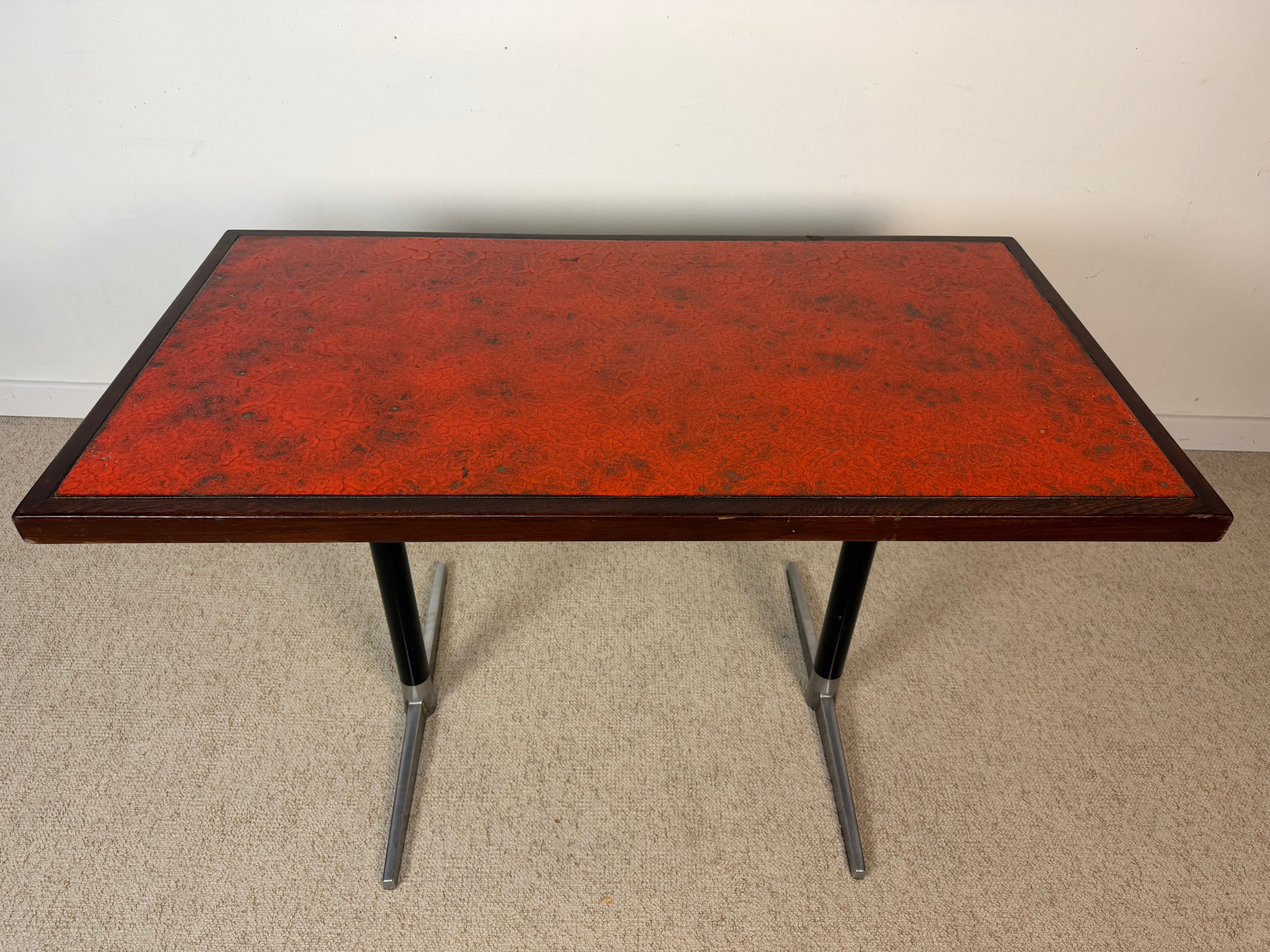 Vintage bistro table with orange-red ceramic.