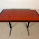 Vintage bistro table with orange-red ceramic.