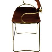 Contemporary sculptural bar stool with a metal back in aged brass and cognac leather.