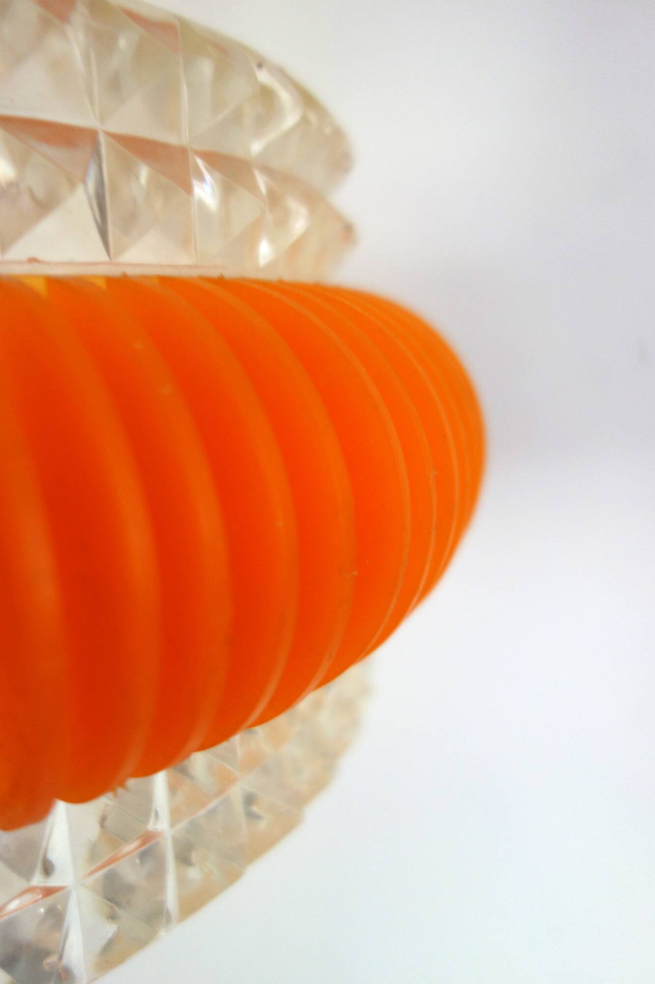 Transparent plastic space age lustre with orange band from the 70s.