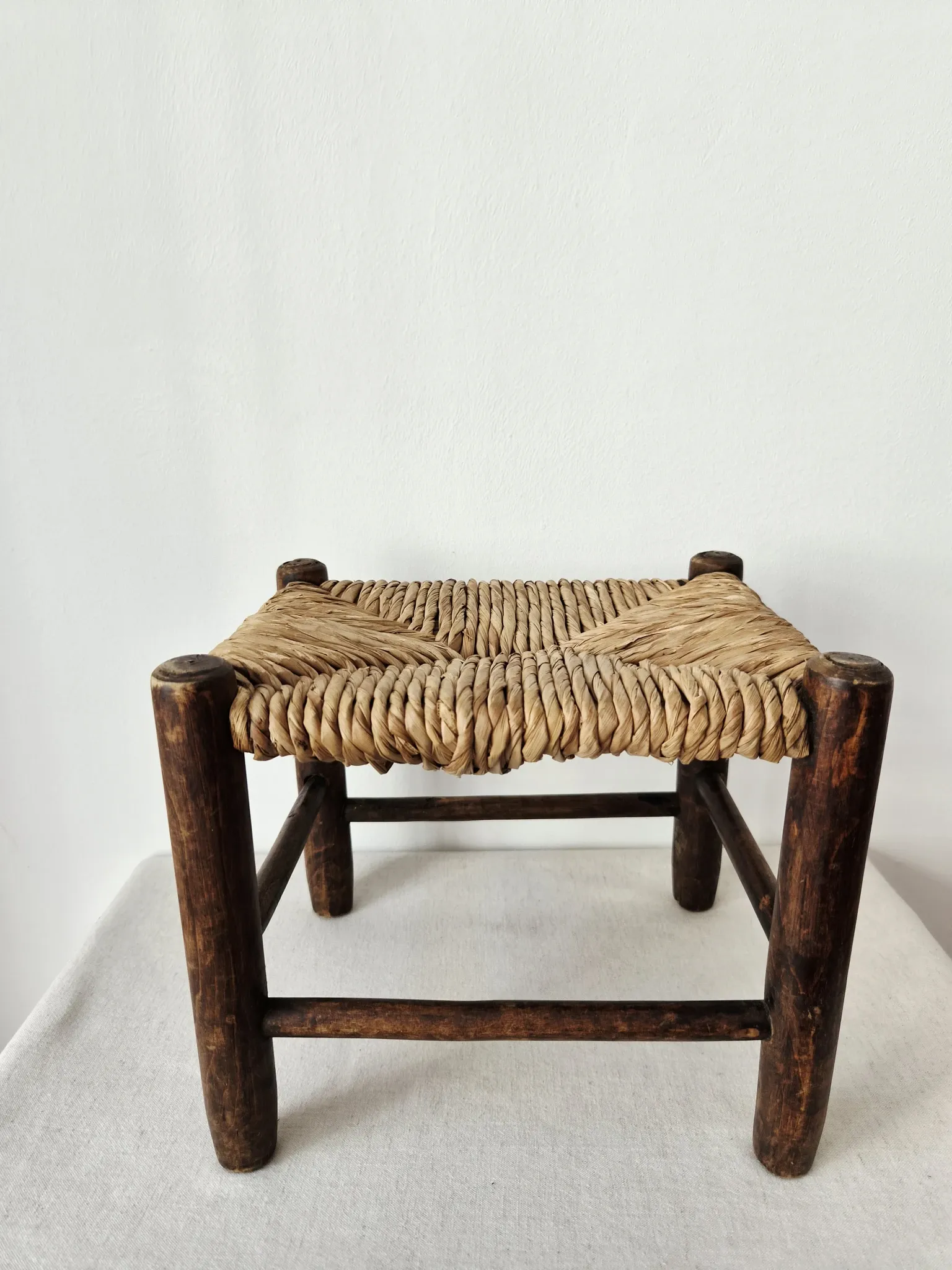 Small rustic vintage wooden and straw stool -