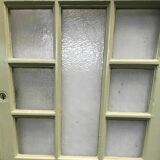 Service door with small tiles and 20th century glass impost