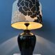 Small Space Age table lamp with a porcelain base and black and white flower shade.