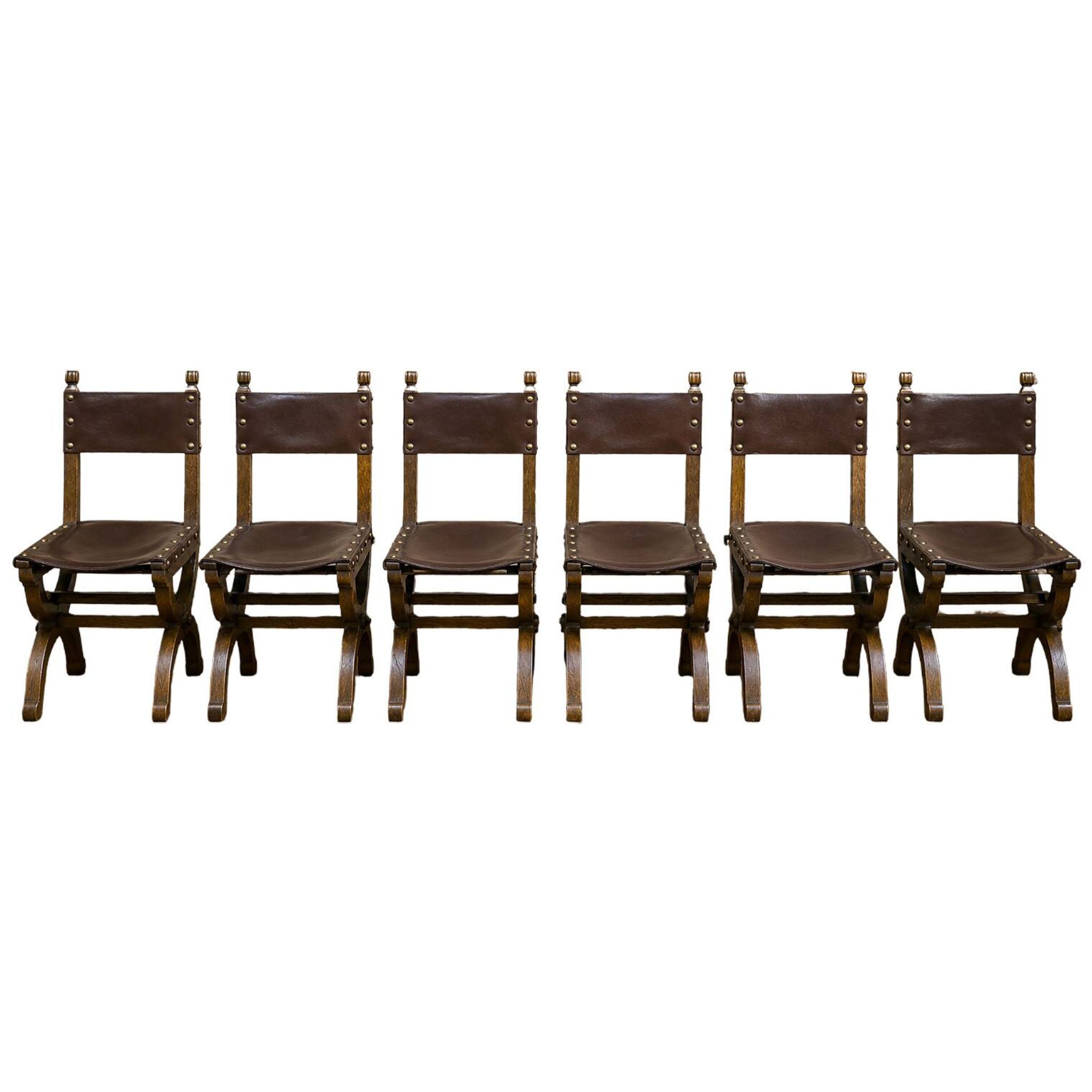 Set of six Renaissance-style chairs in oak and leather.