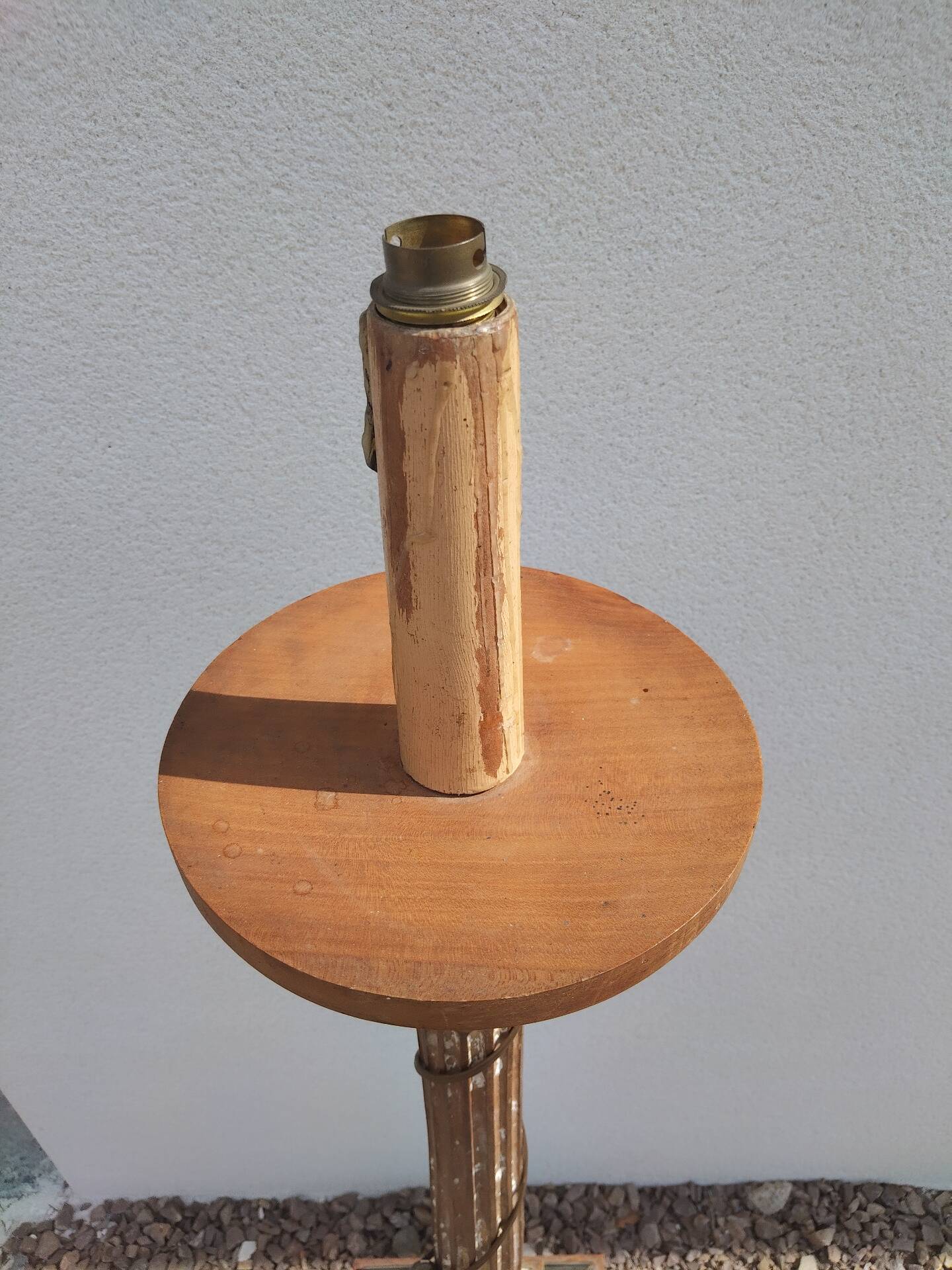 Large antique church candlestick in carved wood transformed into a lamp.