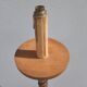 Large antique church candlestick in carved wood transformed into a lamp.
