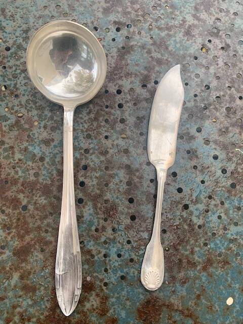 Lot of mismatched silver metal serving cutlery, a ladle and a fish knife