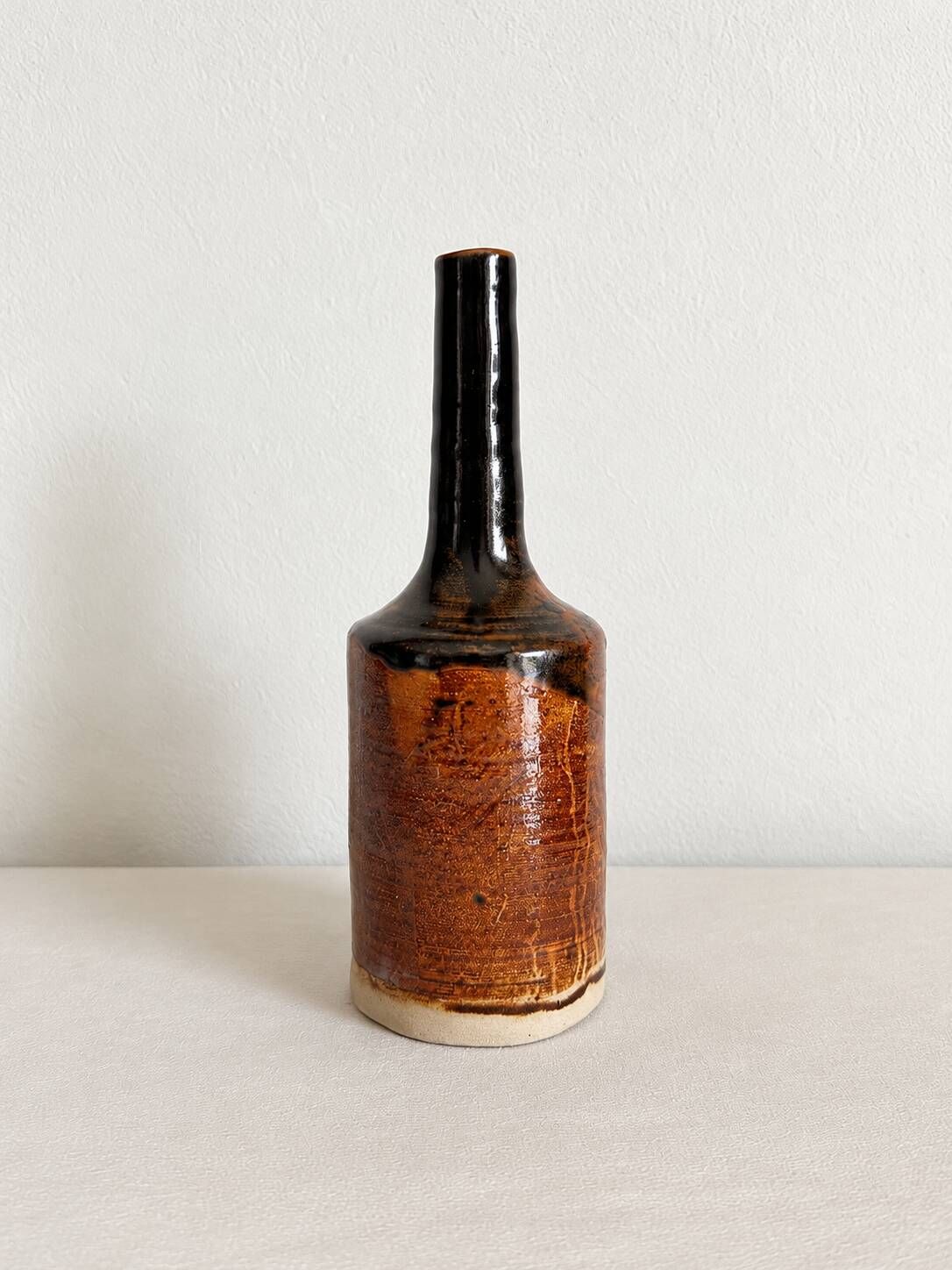 Brown and black glazed stoneware single flower vase, antique handmade pottery.