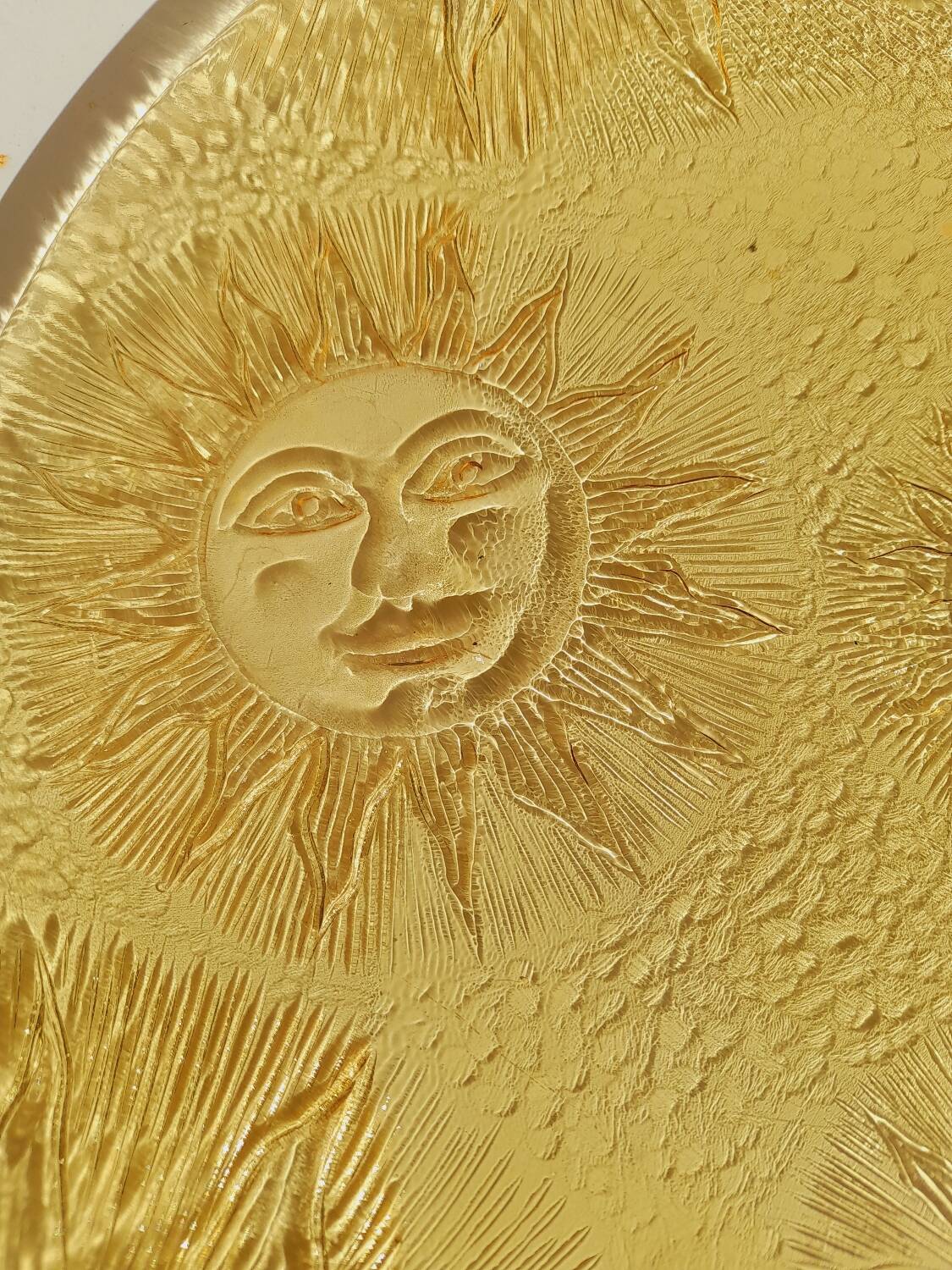 Glass plate decorated with suns, 1980.