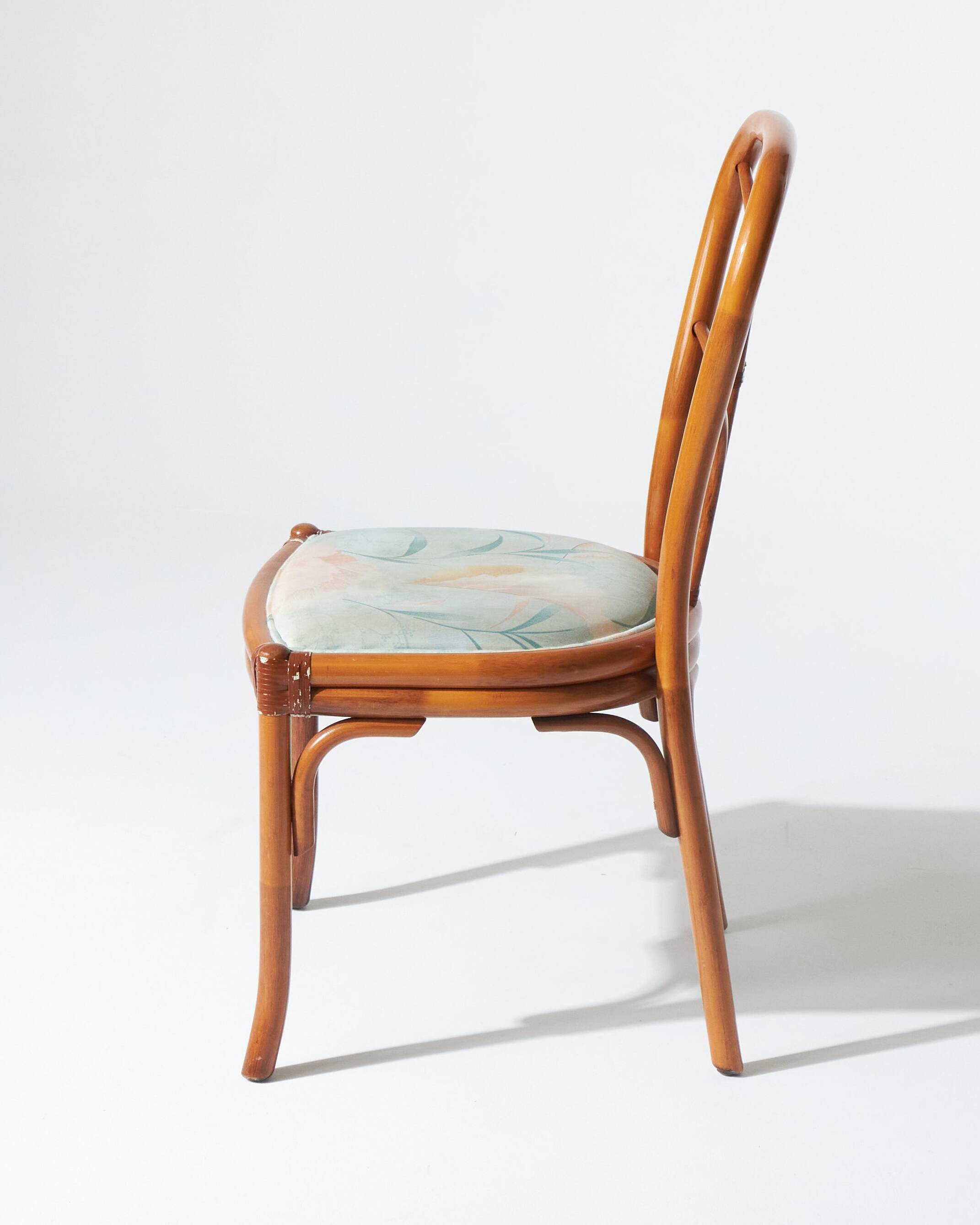 Pair of rattan and blue floral fabric chairs