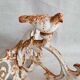 Wall lamp in antique cast iron with bird and scroll decorations.