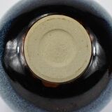 Vase with blue flowers.