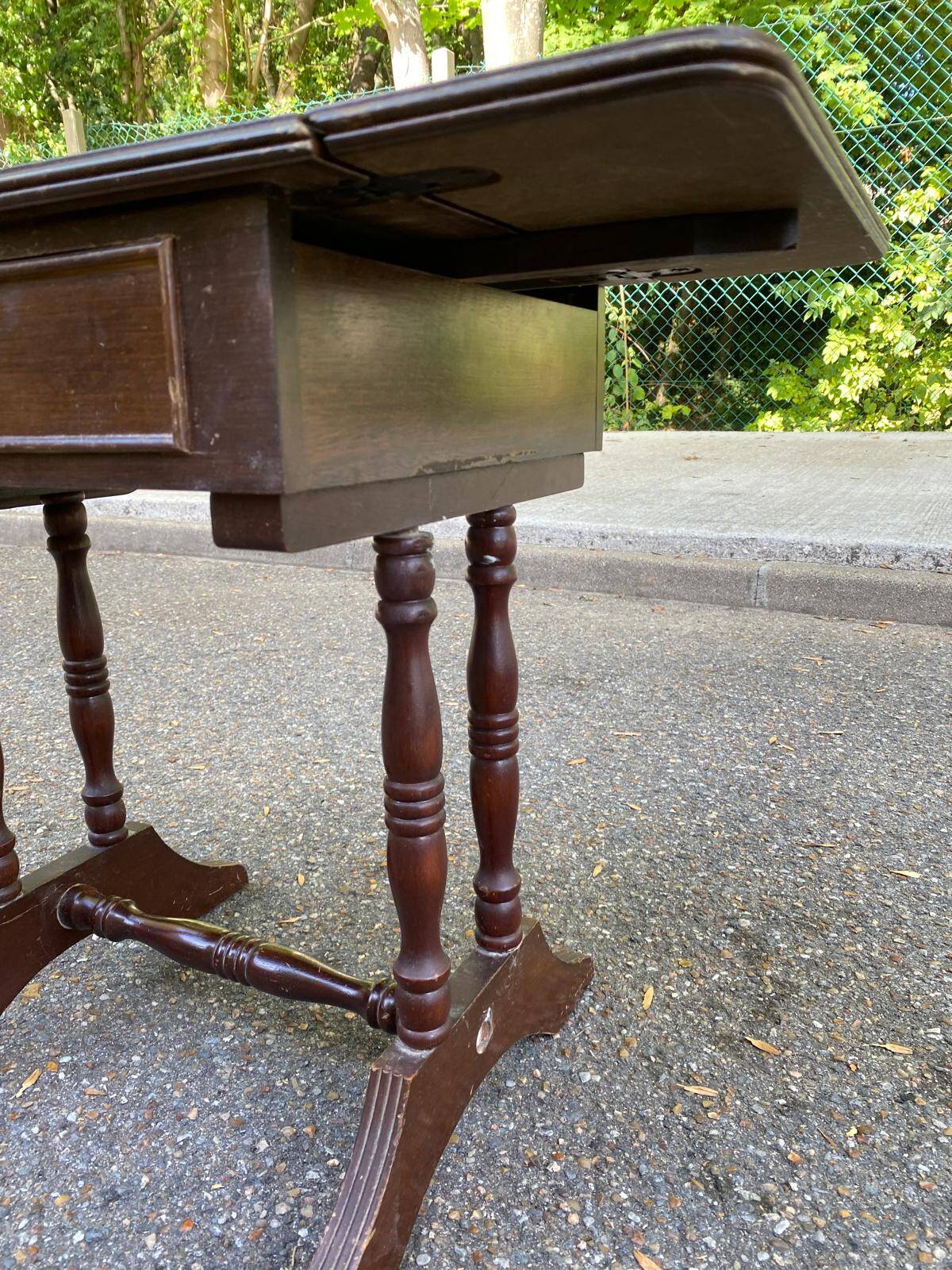 Small drop-leaf side table in English style with leather top & drawer.