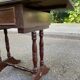 Small drop-leaf side table in English style with leather top & drawer.
