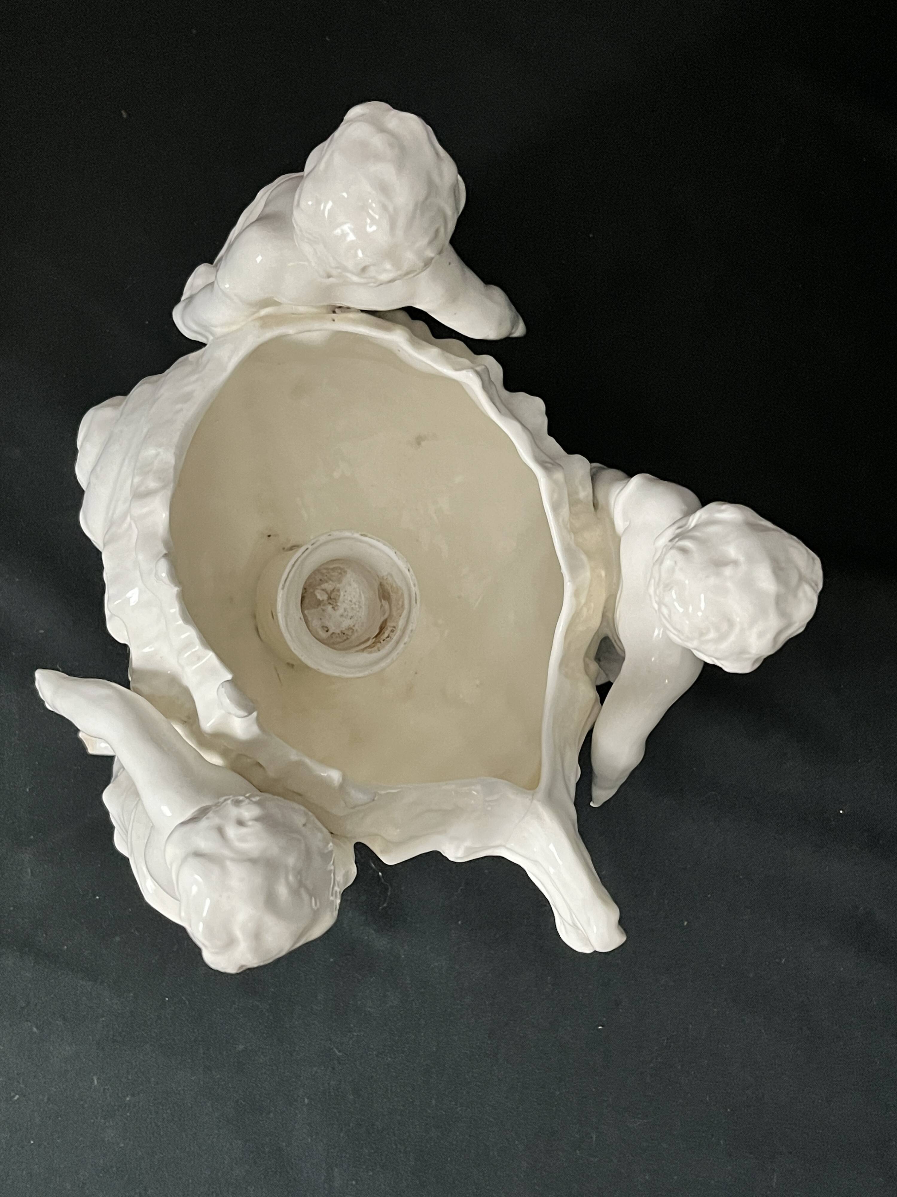 Porcelain, centerpiece with candle holder decorated with putti, 20th century