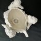 Porcelain, centerpiece with candle holder decorated with putti, 20th century