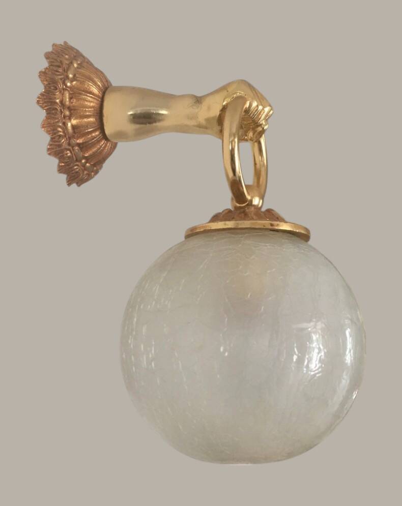 Wall light with golden hand and glass globe