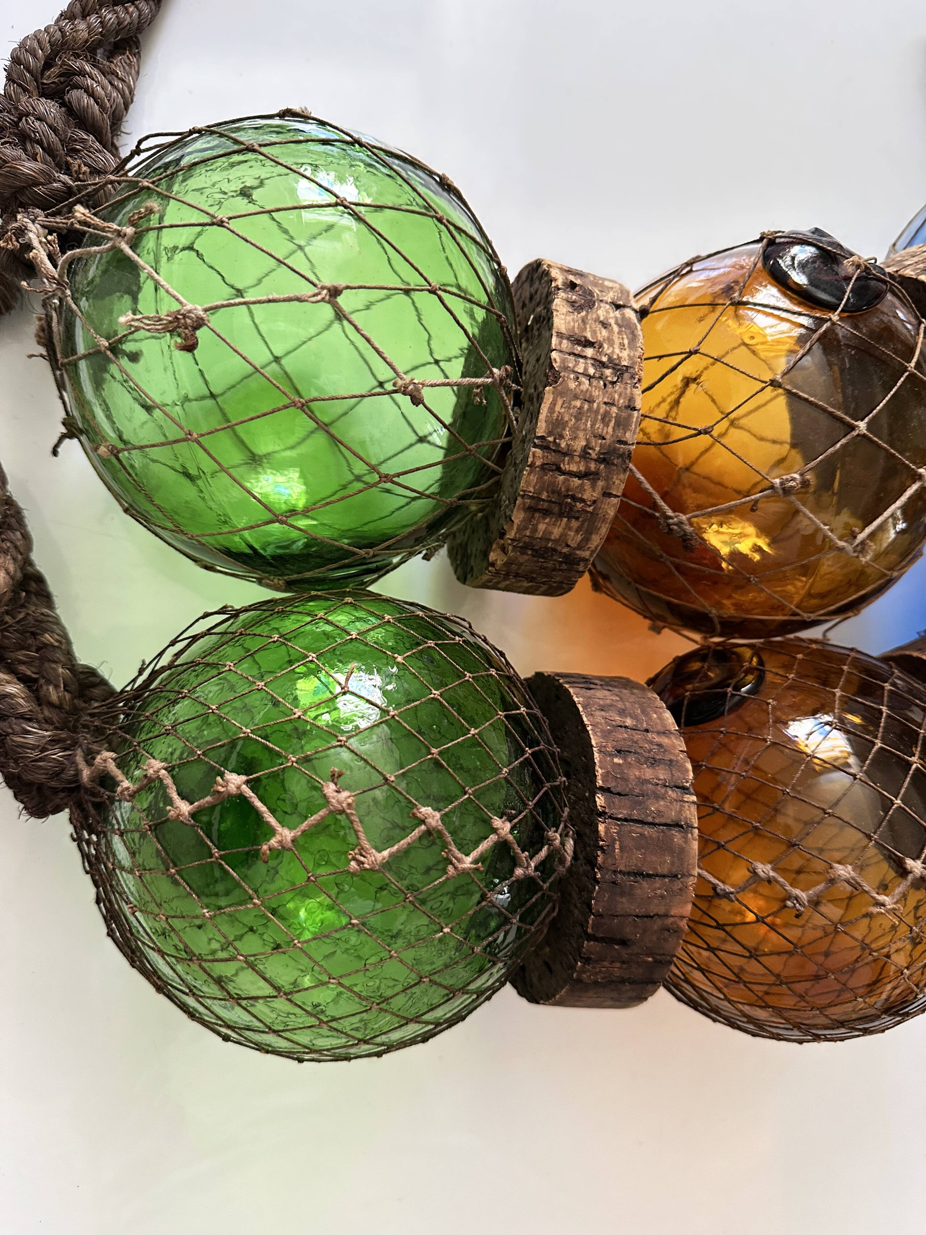Fishing floats made of blown glass, cork, and rope. France, 1960s.