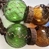 Fishing floats made of blown glass, cork, and rope. France, 1960s.