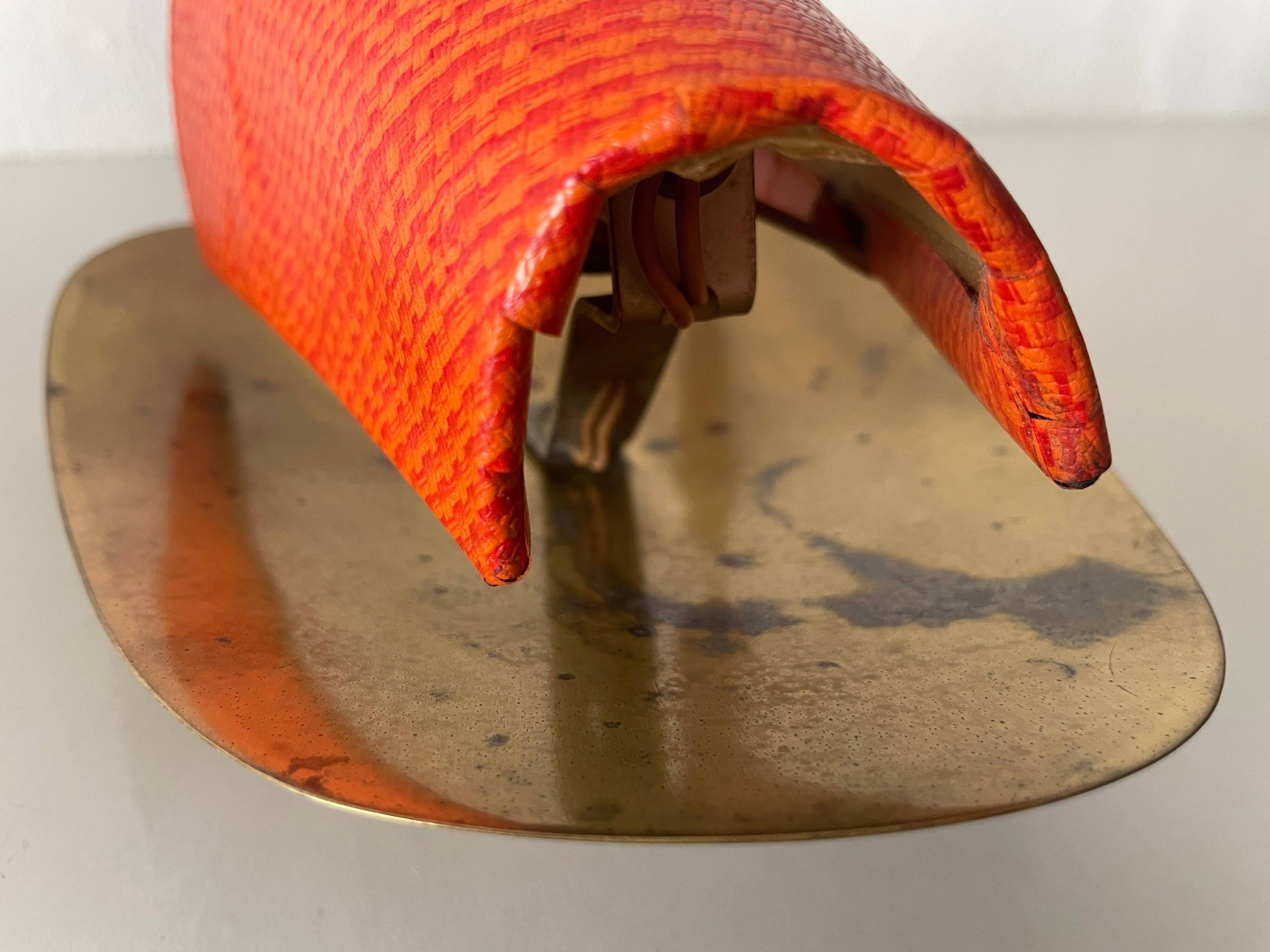 Pair of orange plexiglass and curved brass wall lights, 1950s, Germany