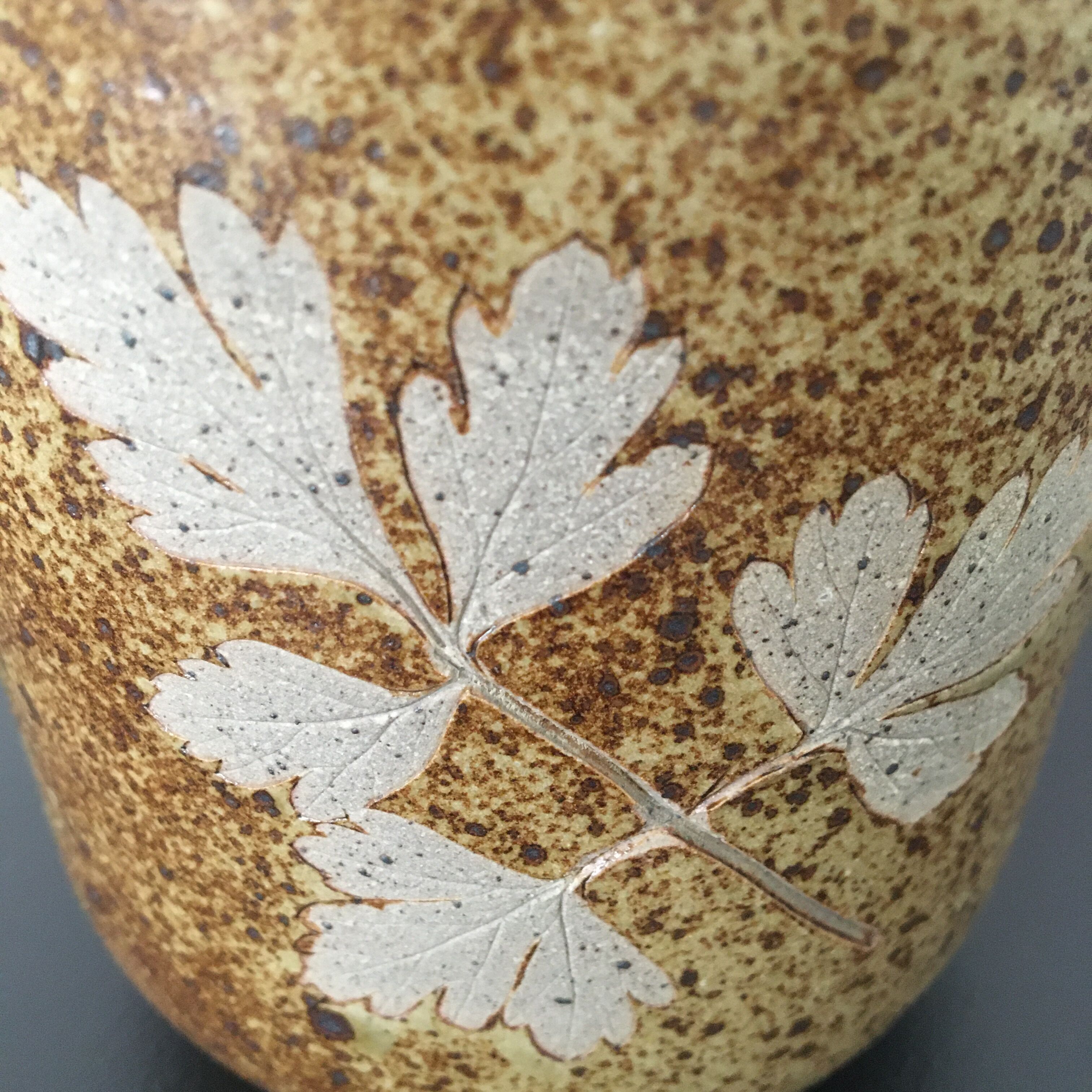 Enamelled sandstone vase decoration foliage